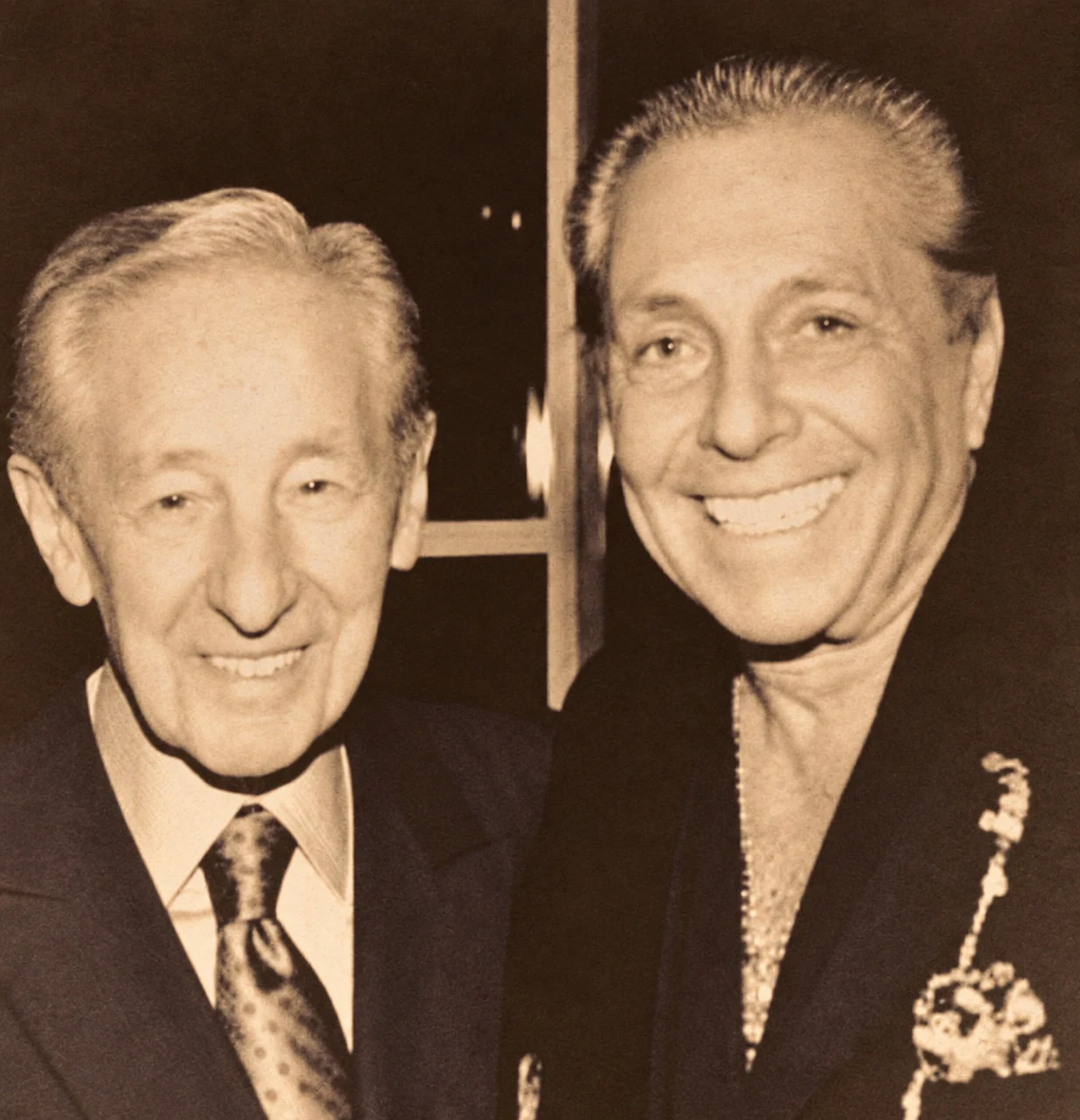 Carlo Gambino beside Gianni Russo in a restored sepia archive photograph